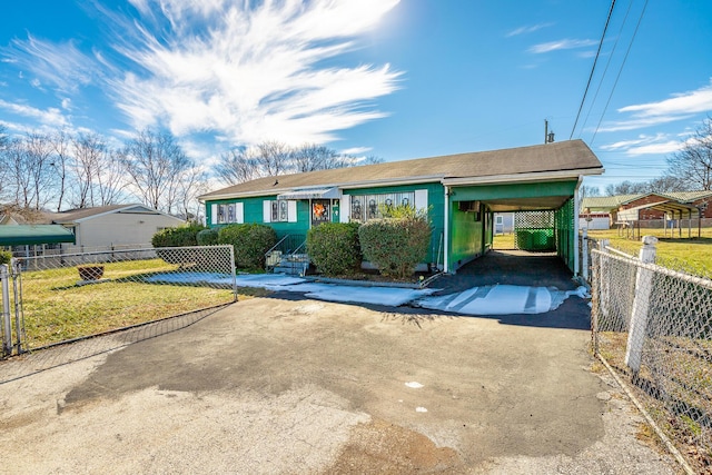 ranch-style home featuring a front yard and a carport