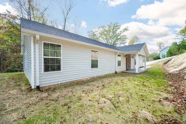 view of side of property with a yard