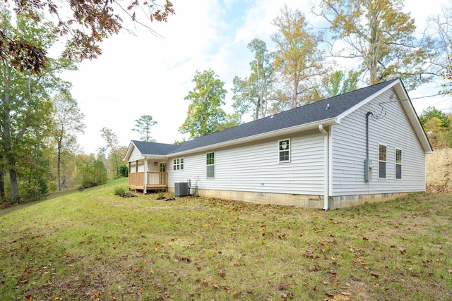 back of property featuring a yard, central AC, and a deck