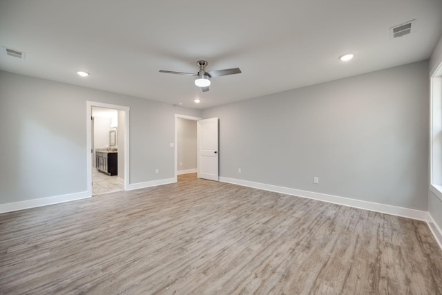 spare room featuring light hardwood / wood-style floors and ceiling fan