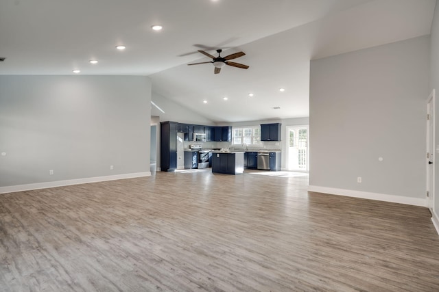 unfurnished living room with hardwood / wood-style floors, ceiling fan, and lofted ceiling