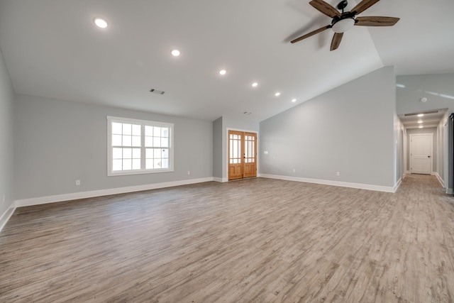 unfurnished living room with french doors, ceiling fan, light hardwood / wood-style flooring, and lofted ceiling