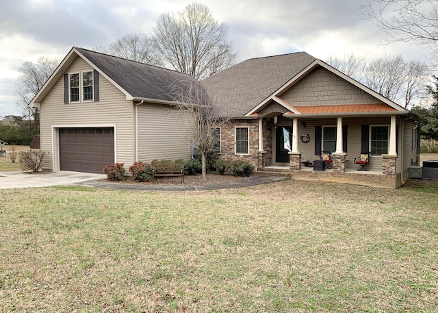 view of front facade with a front yard, a porch, and a garage