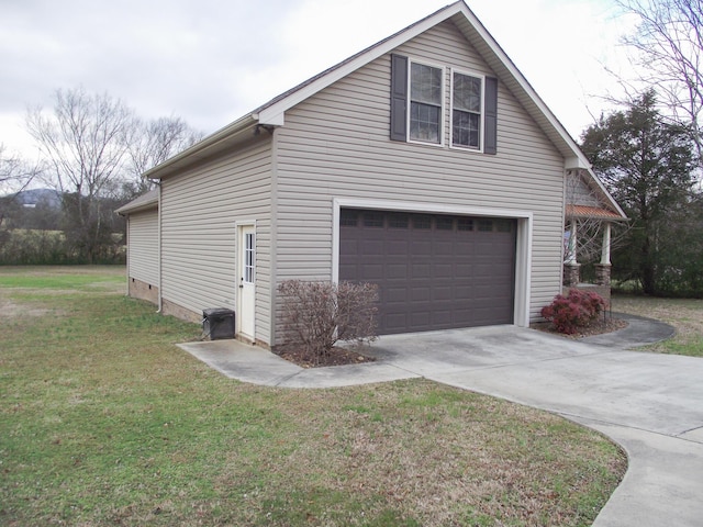 view of side of home featuring a yard and a garage