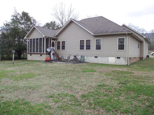 back of property featuring a lawn, a patio area, and a sunroom