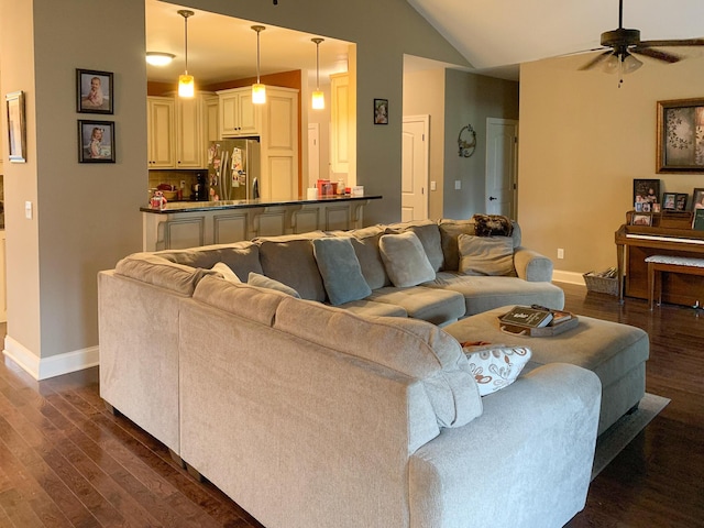 living room featuring ceiling fan, dark hardwood / wood-style floors, and lofted ceiling