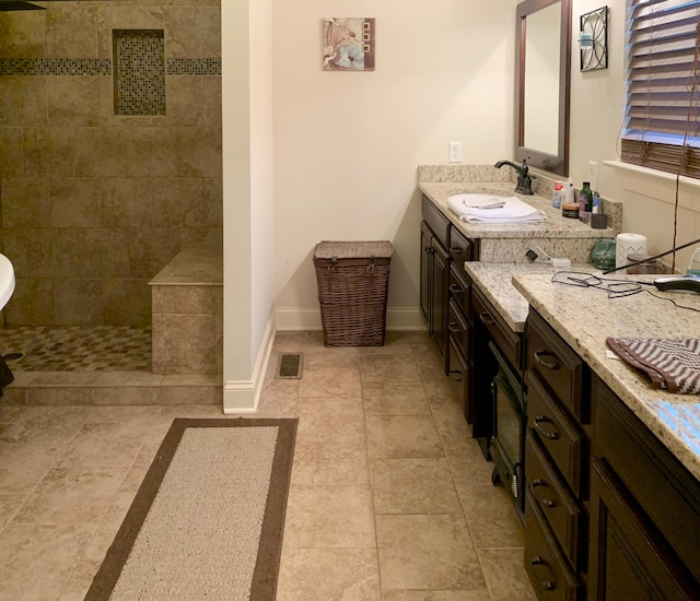 bathroom featuring vanity and a tile shower