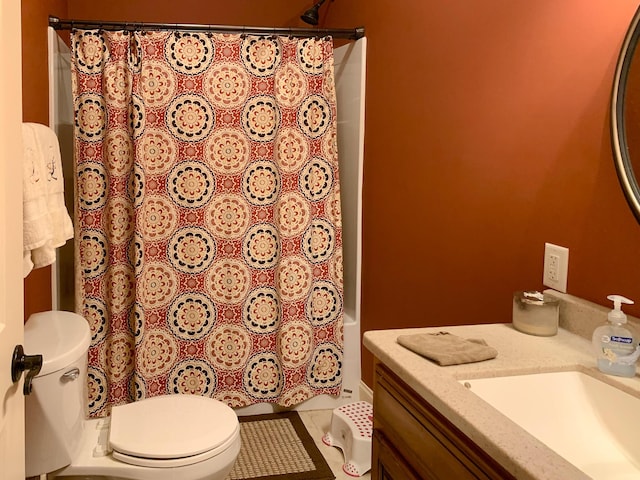 bathroom featuring tile patterned floors, vanity, and toilet