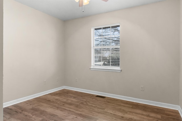 spare room featuring hardwood / wood-style floors and ceiling fan