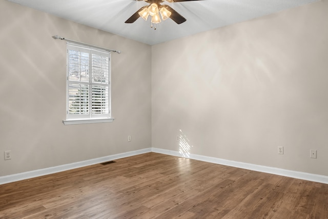 unfurnished room with hardwood / wood-style flooring and ceiling fan