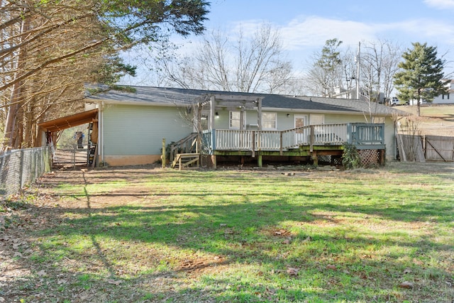 rear view of property featuring a wooden deck and a lawn