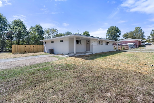 ranch-style home with a front lawn and central AC unit