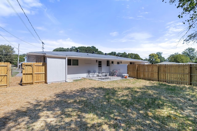 back of property with a patio