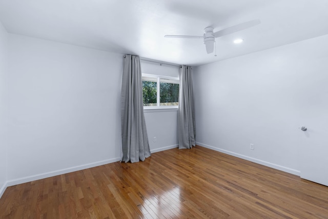 empty room with wood-type flooring and ceiling fan