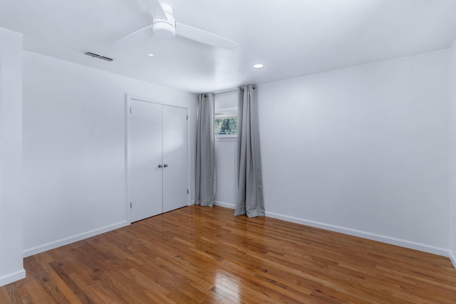 empty room featuring hardwood / wood-style floors and ceiling fan