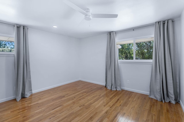 spare room featuring light hardwood / wood-style flooring and ceiling fan