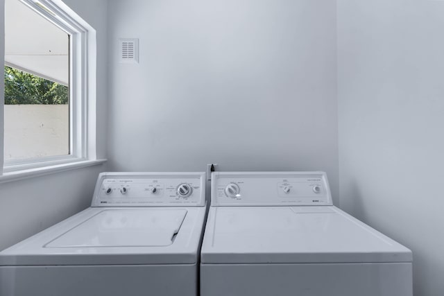 clothes washing area featuring washer and dryer