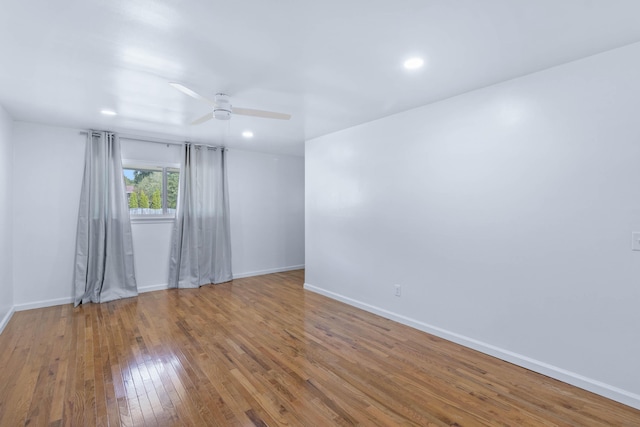 empty room with wood-type flooring and ceiling fan