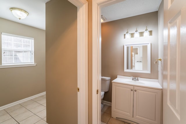 bathroom featuring tile patterned flooring, vanity, and toilet