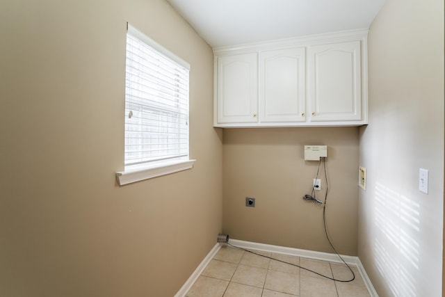 laundry room featuring plenty of natural light, light tile patterned flooring, washer hookup, and hookup for an electric dryer