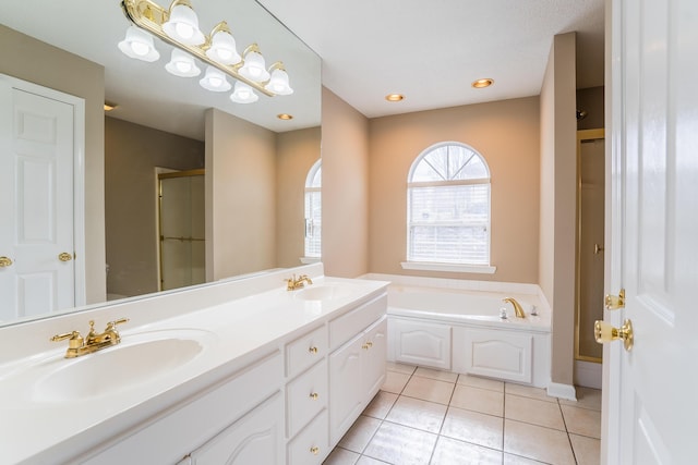 bathroom with tile patterned flooring, vanity, and separate shower and tub