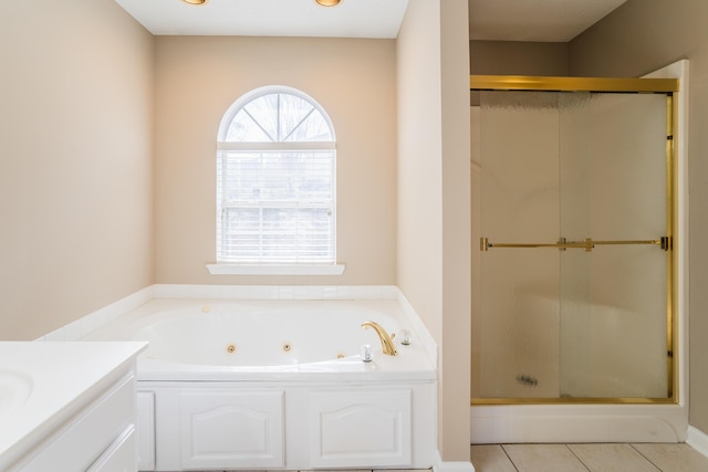 bathroom with tile patterned floors, vanity, and plus walk in shower