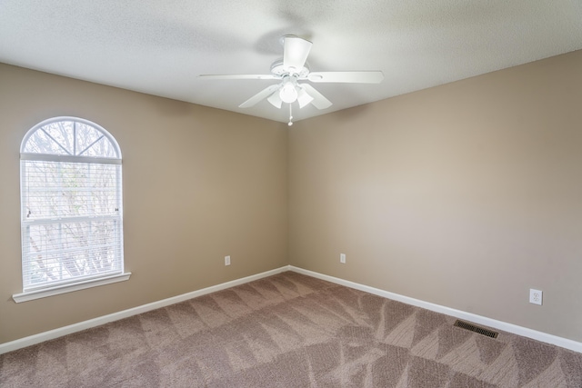 empty room with carpet and ceiling fan