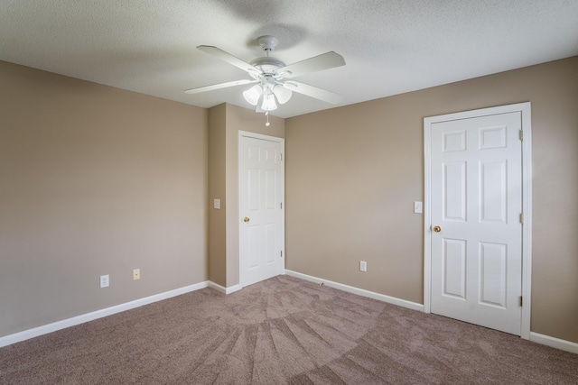 unfurnished room with light carpet, a textured ceiling, and ceiling fan