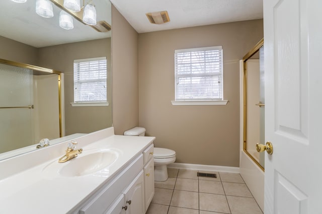 full bathroom featuring tile patterned floors, vanity, a healthy amount of sunlight, and toilet