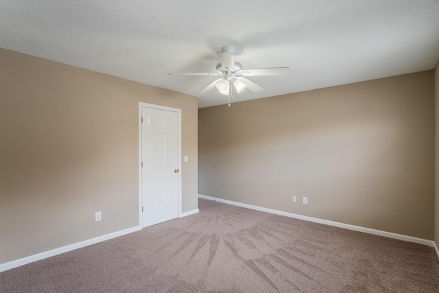 spare room with ceiling fan and light colored carpet