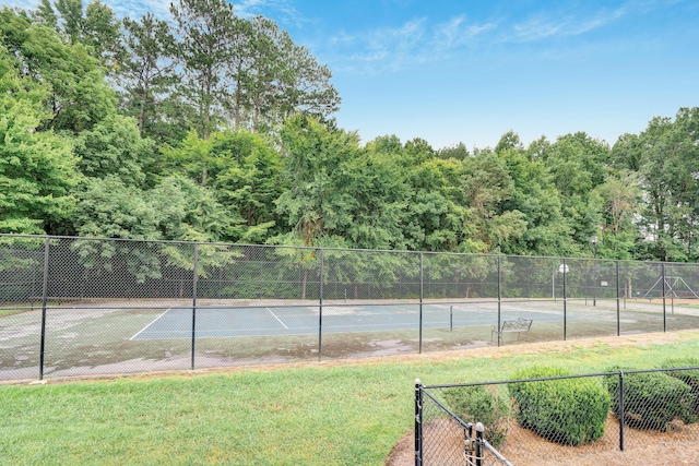 view of sport court featuring a yard