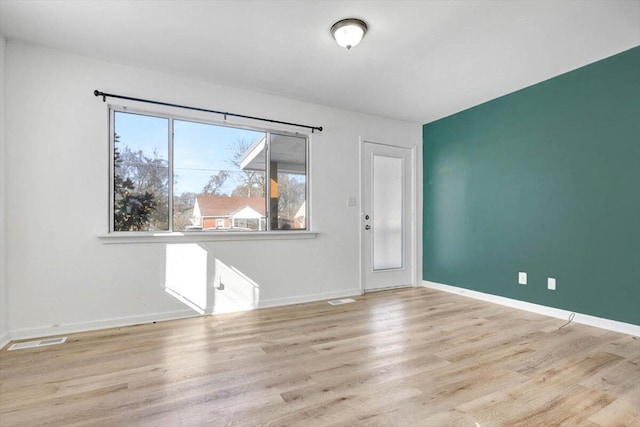 empty room with light hardwood / wood-style flooring