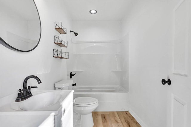 full bathroom featuring vanity, toilet, wood-type flooring, and washtub / shower combination