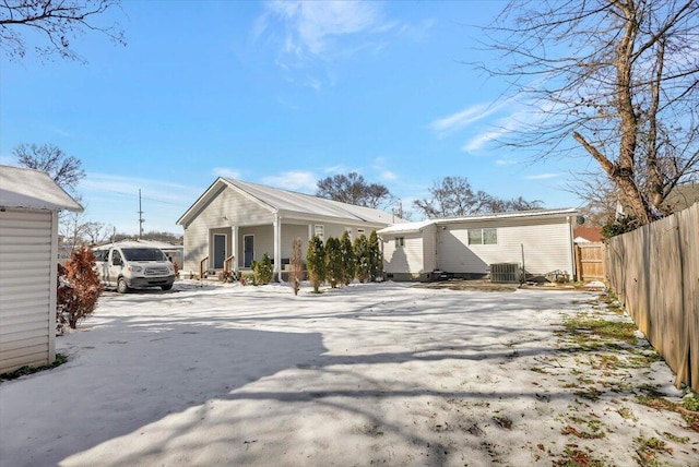 rear view of house featuring a porch and central air condition unit