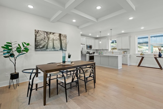 dining room featuring beam ceiling, light wood-type flooring, and coffered ceiling