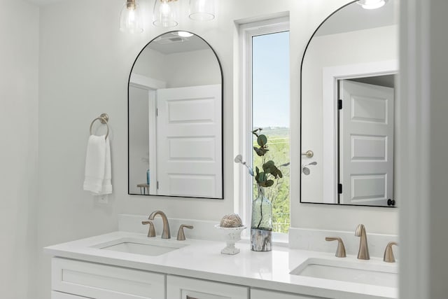 bathroom with plenty of natural light and vanity