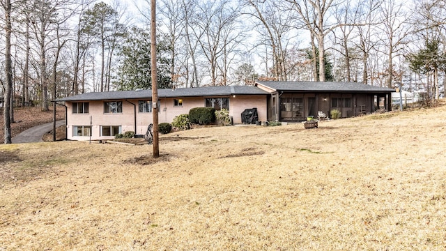 back of property featuring a yard