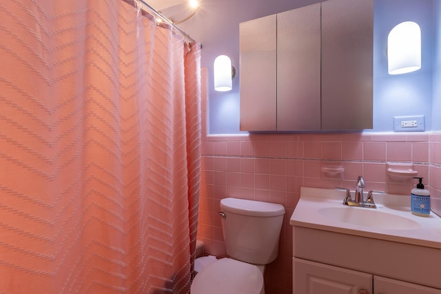 full bathroom with vanity, tile walls, toilet, and shower / bathtub combination with curtain