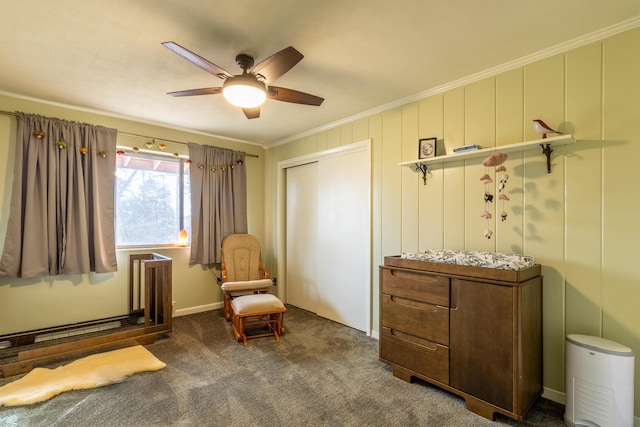 sitting room with crown molding, ceiling fan, and dark colored carpet