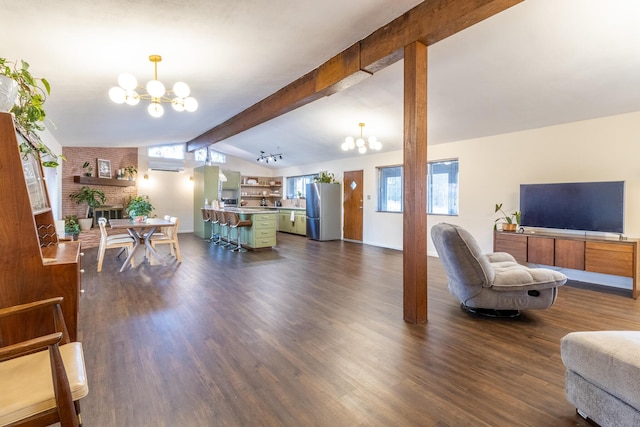 living room featuring an inviting chandelier, a brick fireplace, dark wood-type flooring, and lofted ceiling with beams