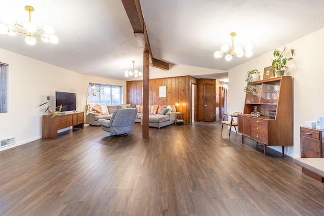 living room featuring lofted ceiling with beams, dark wood-type flooring, wooden walls, and a chandelier