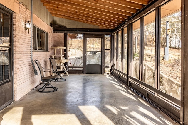 unfurnished sunroom featuring lofted ceiling