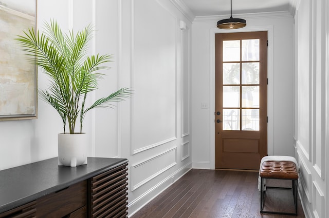 entryway with dark hardwood / wood-style flooring and crown molding