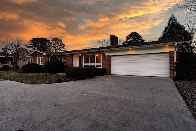 ranch-style home featuring a garage