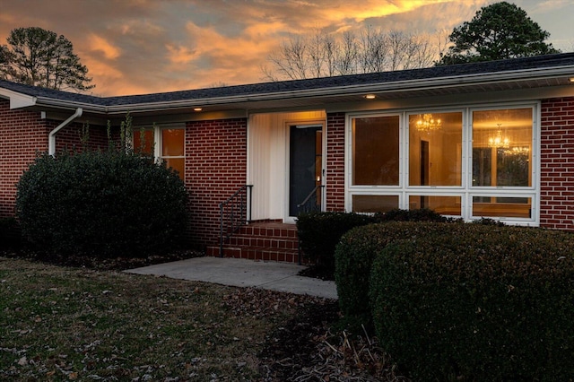 view of exterior entry at dusk