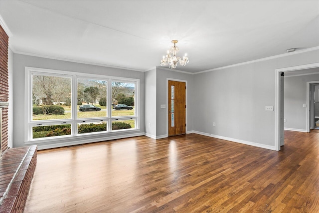 interior space with ornamental molding, dark hardwood / wood-style flooring, a brick fireplace, and a chandelier