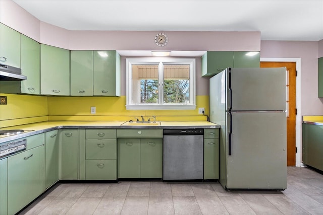 kitchen with sink, refrigerator, dishwasher, and green cabinets