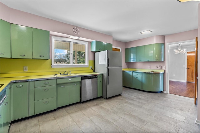 kitchen with refrigerator, dishwasher, and green cabinets