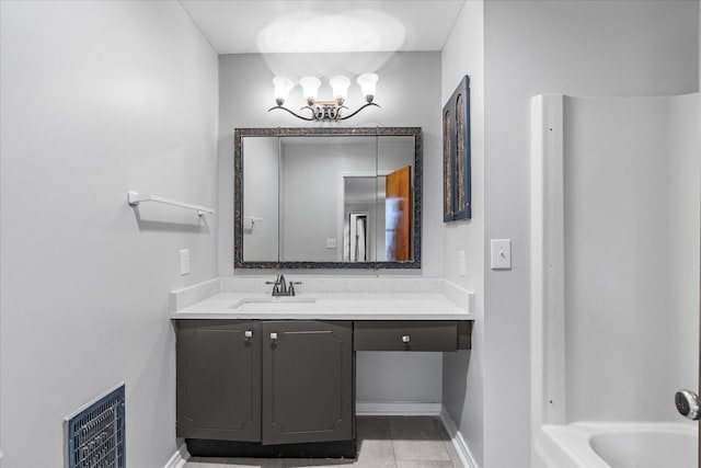 bathroom featuring tile patterned floors, a tub to relax in, and vanity