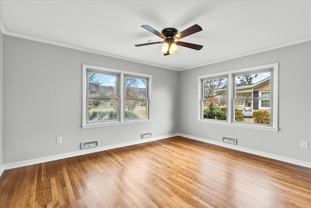 unfurnished room with a healthy amount of sunlight, ceiling fan, crown molding, and hardwood / wood-style flooring